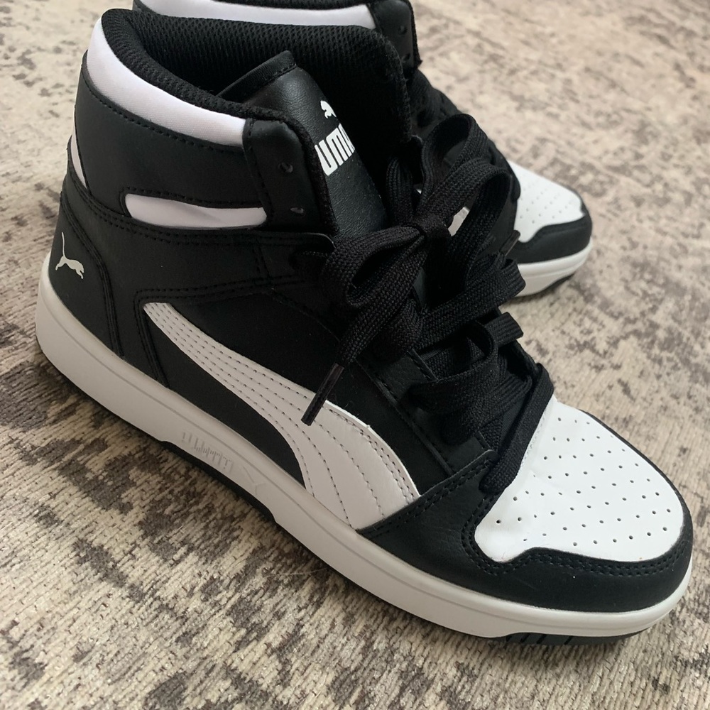 Black and white Puma high top sneakers